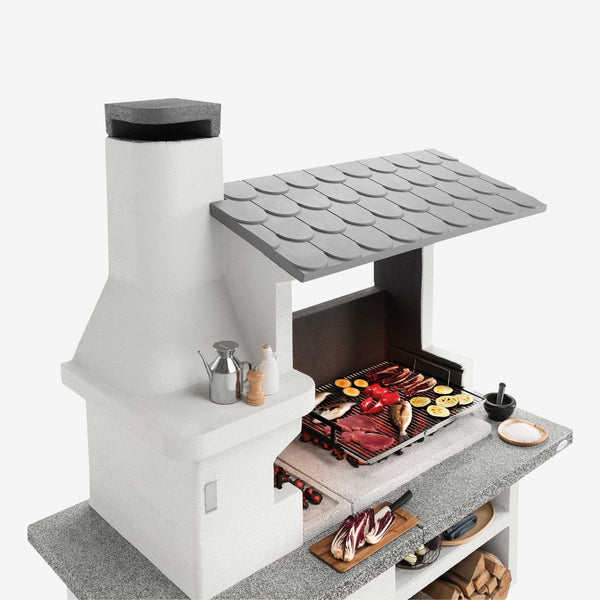 Barbecue in cemento a legna TRINIDAD con griglia extra large - PALAZZETTI braciere laterale, piano Marmotech e struttura in cemento