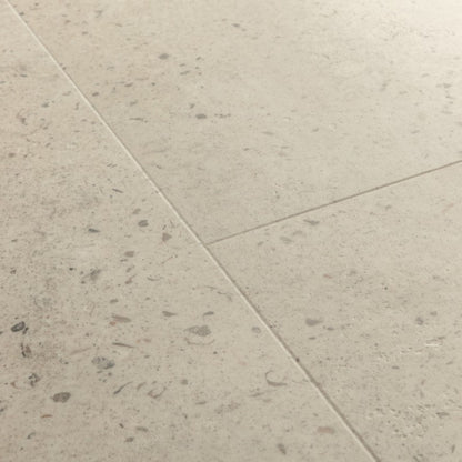 Pavimento in PVC ILLUME CEMENTO OSTRICA QUICK-STEP pietra con tonalità grigio chiaro consente di valorizzare ambienti luminosi e ordinati