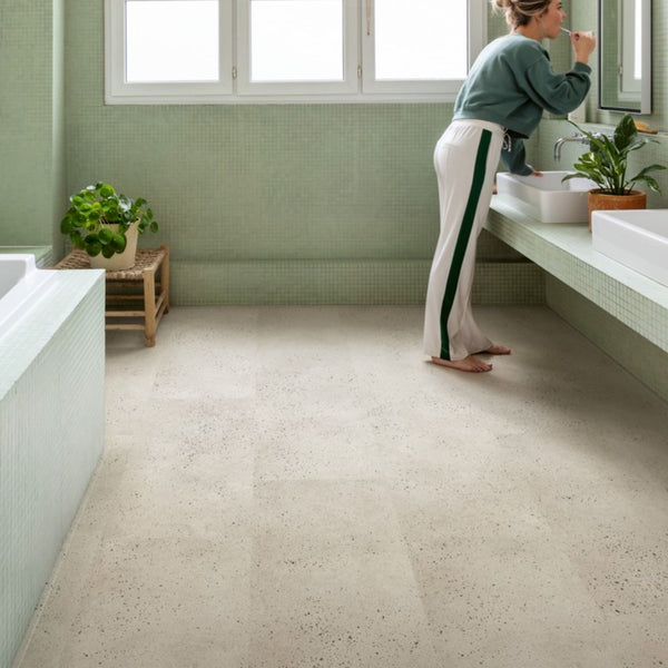 Pavimento in PVC ILLUME CEMENTO OSTRICA QUICK-STEP pietra con tonalità grigio chiaro consente di valorizzare ambienti luminosi e ordinati